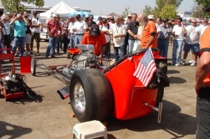 Group of people with drag car engine