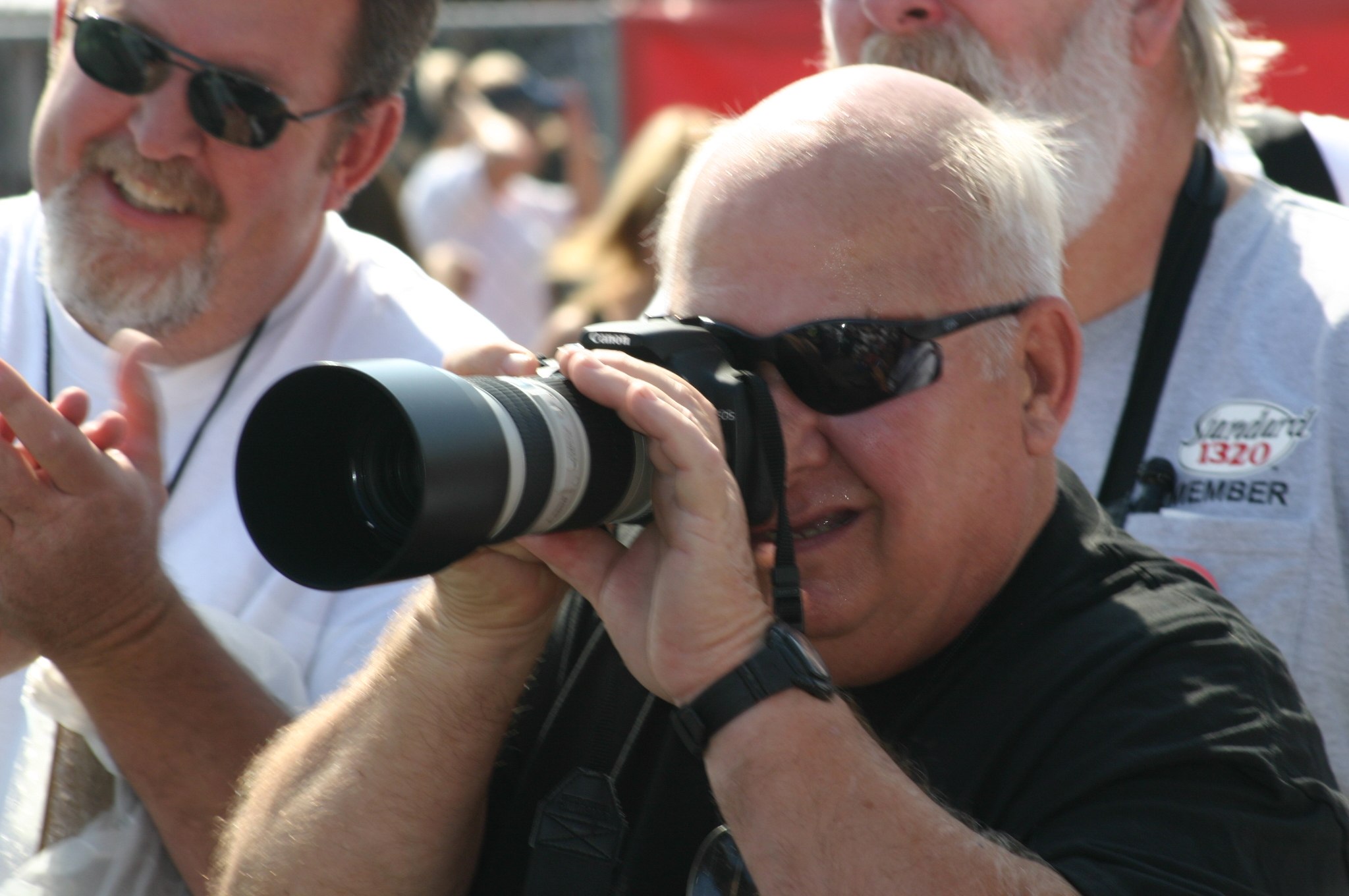 A picture of a man capturing racing moments
